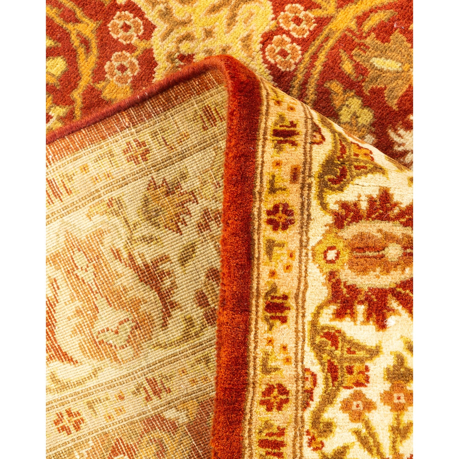 Close-up of folded oriental carpet showcasing intricate patterns and rich colors.