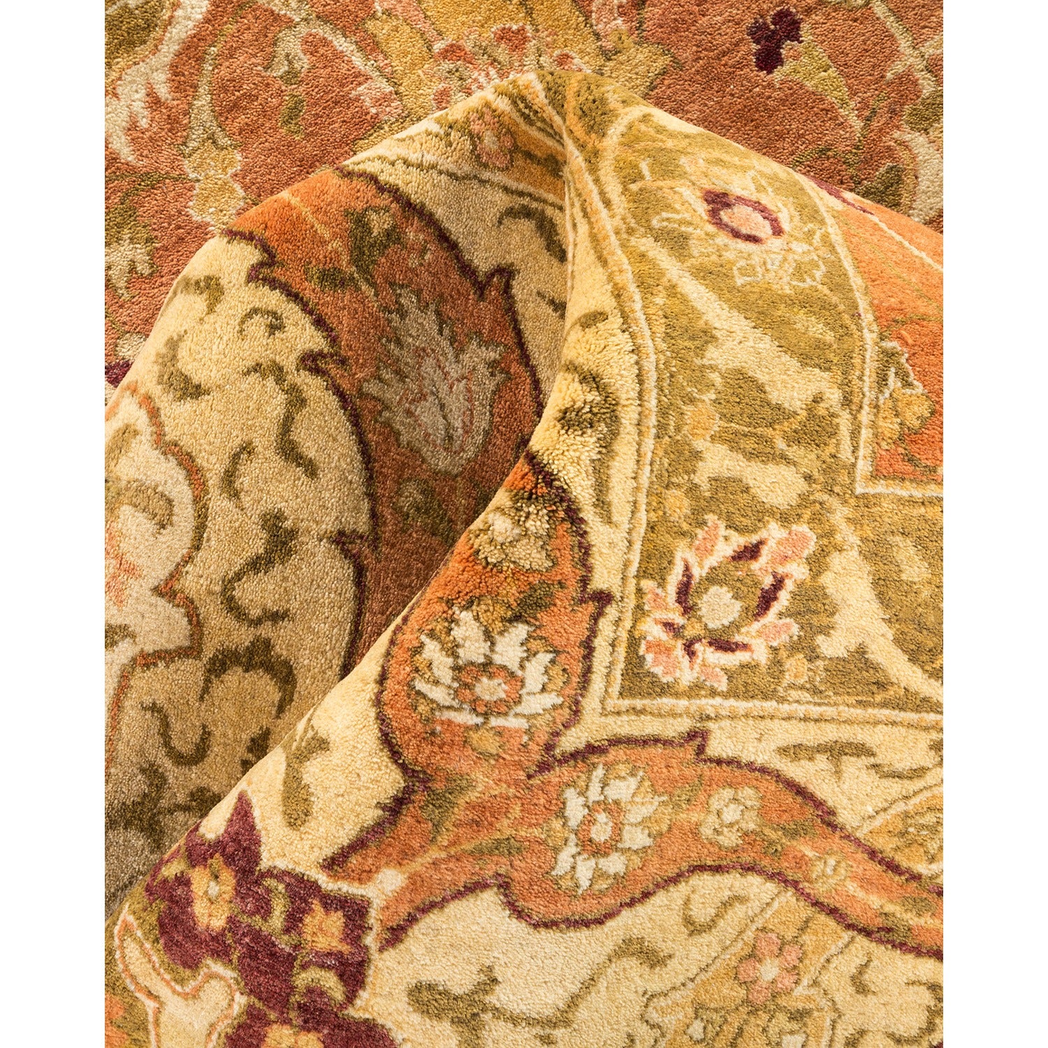 Close-up view of an intricately patterned, plush handmade oriental rug.