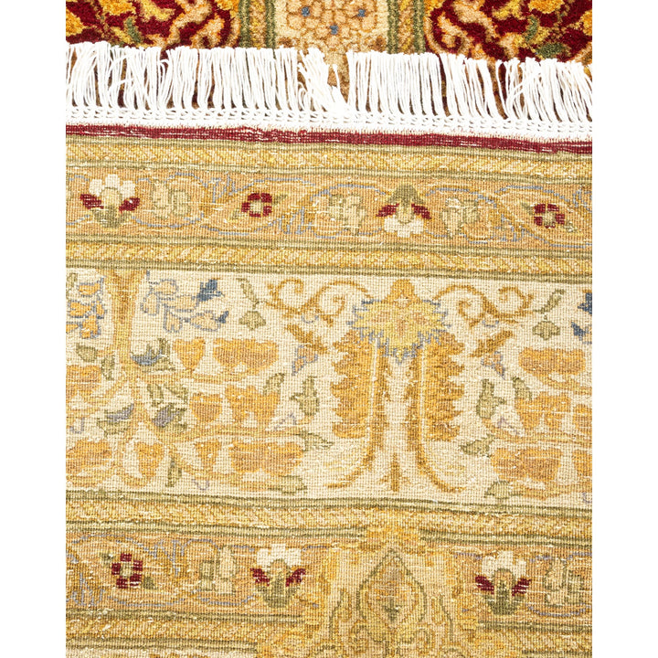 Exquisite hand-woven rug displays intricate floral and geometric motifs.