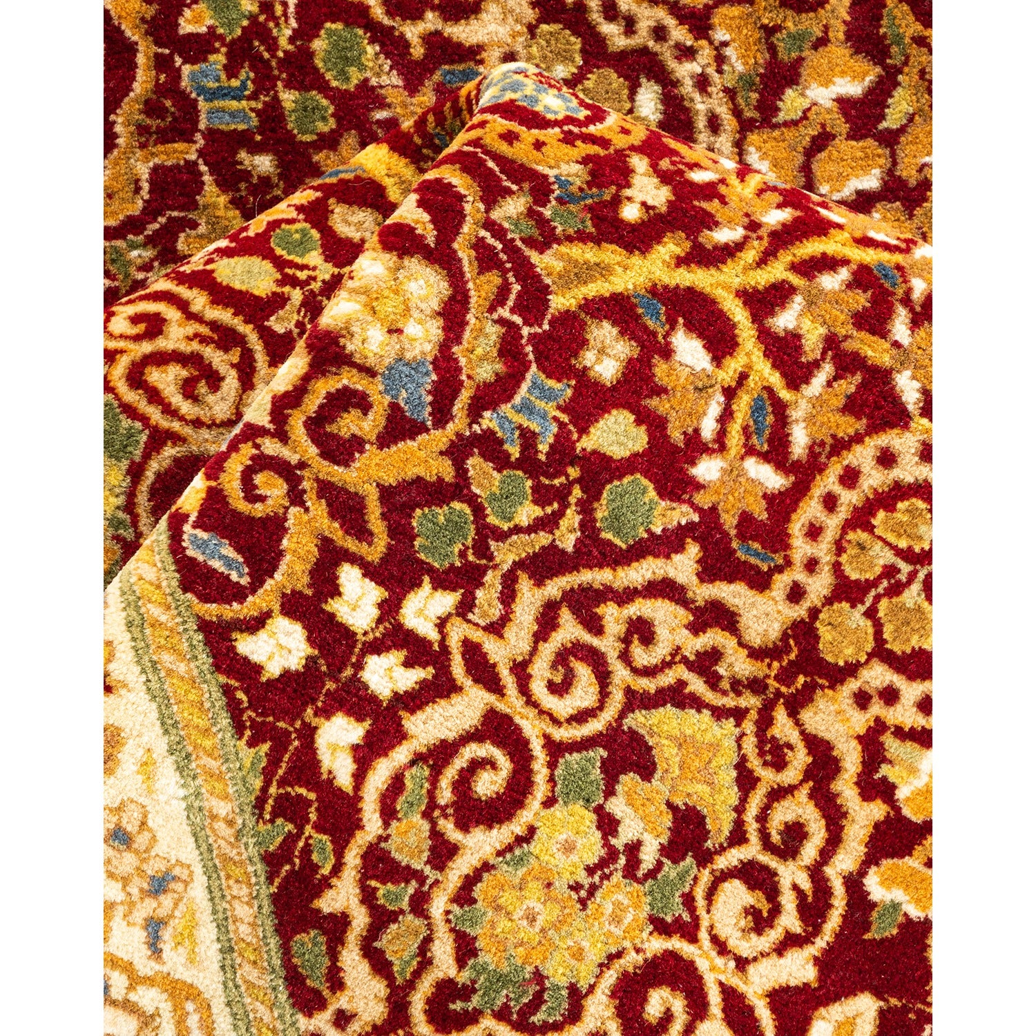 Close-up of a richly patterned, plush red carpet with intricate designs.