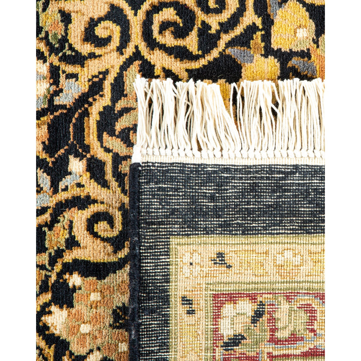 Close-up of a traditional handcrafted rug with floral motifs and fringe.