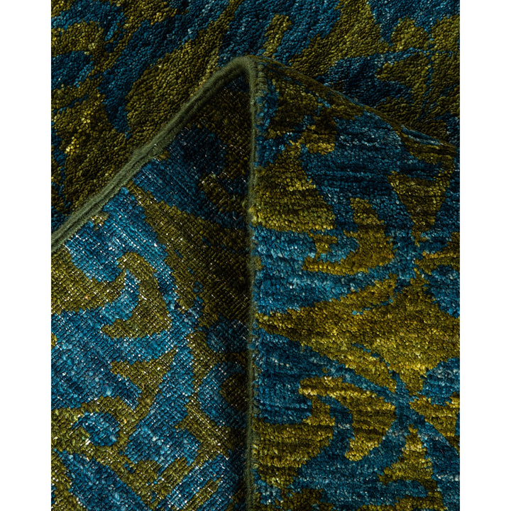 Close-up of folded fabric with intricate blue and gold pattern
