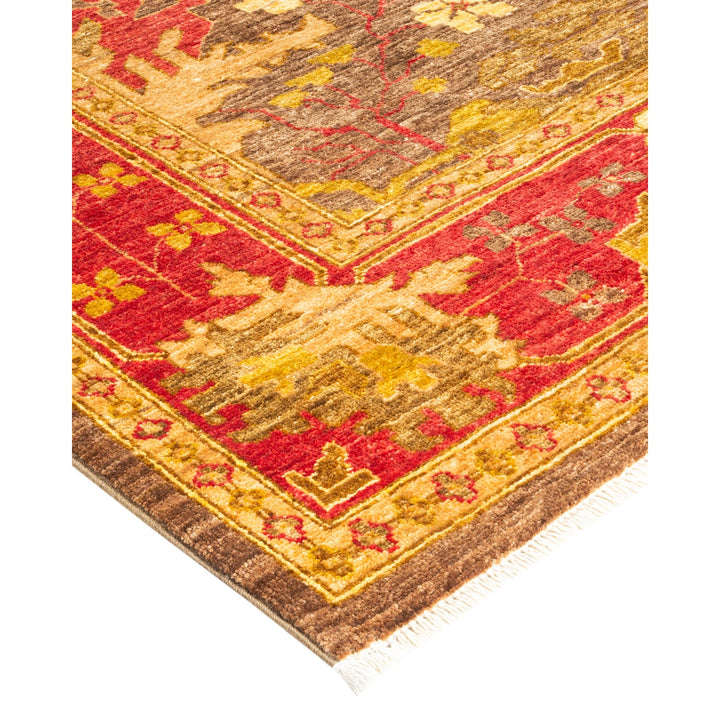 Close-up view of an ornate rug with geometric and floral pattern.