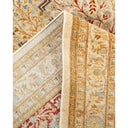 Intricately designed, partially rolled-up Oriental rug showcases exquisite craftsmanship.