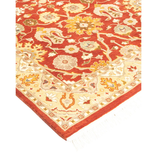 Ornate, handmade carpet with intricate floral motifs and warm colors.