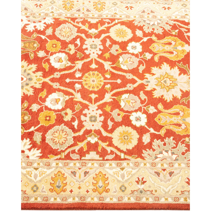 Exquisite, hand-knotted red/orange floral carpet with intricate symmetrical design.