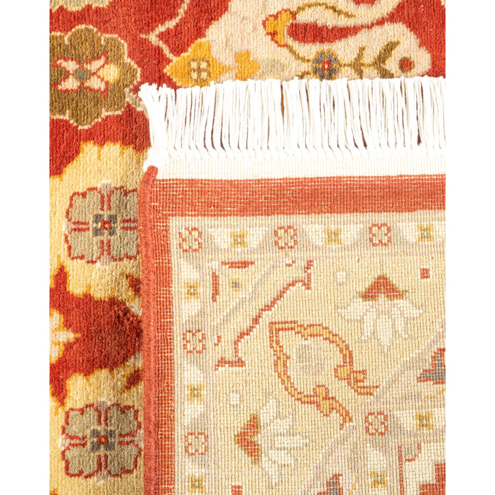 Close-up view of two textile pieces: a plush red carpet with floral and geometric patterns, and a folded cream carpet with delicate motifs.