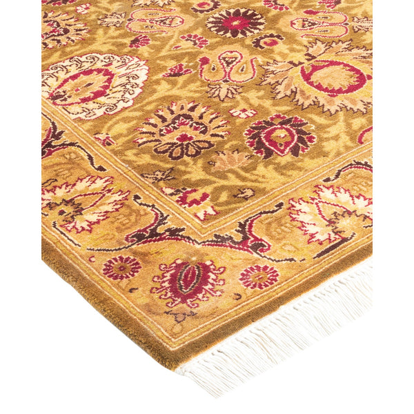 Intricately designed Persian-style rug with golden tan background and fringe