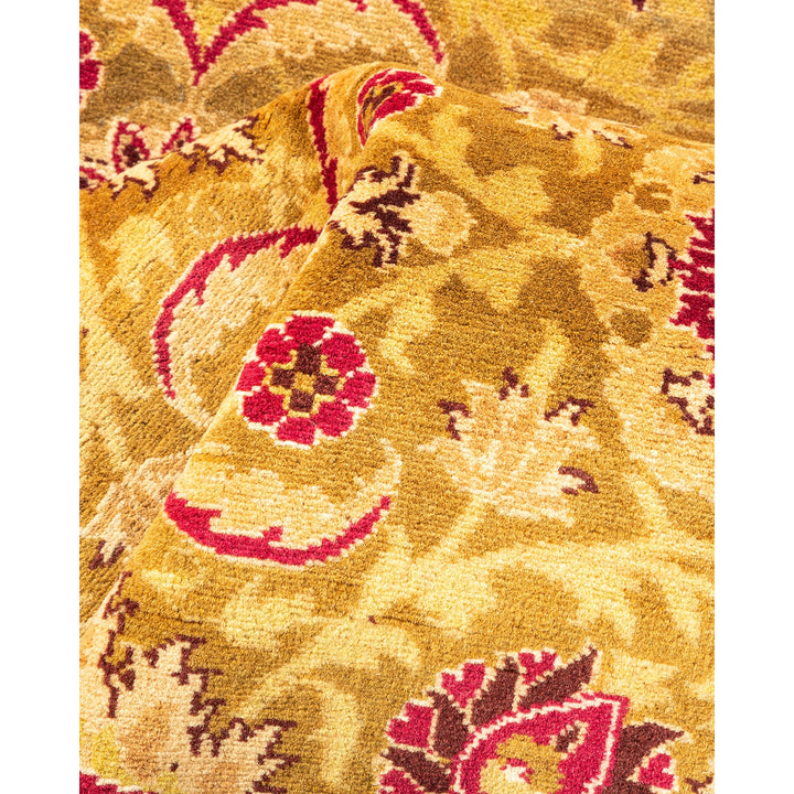 Exquisite carpet showcasing intricate floral and paisley-like motifs in golden tones.