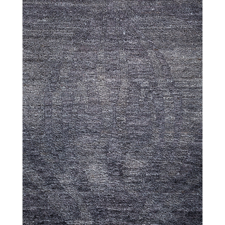 Monochrome gradient textured surface resembling woven fabric or carpet close-up.