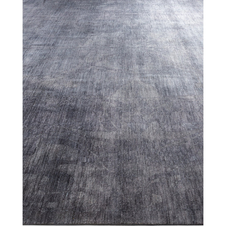 Close-up of dark gray carpet with subtle textured pattern.