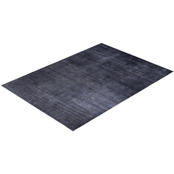 Rectangular rug with gradient pattern on a soft textured surface.