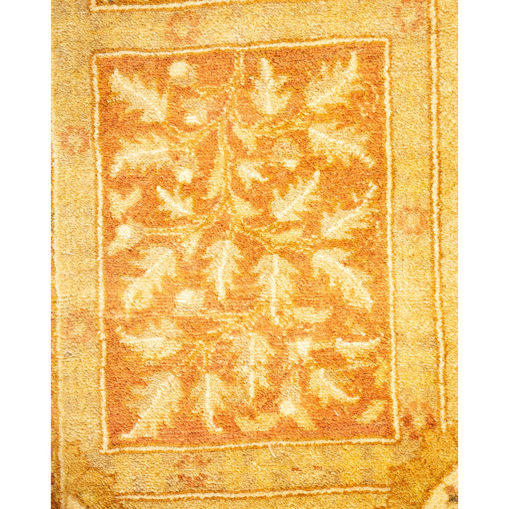 Close-up of an ornate textured carpet with botanical motifs.