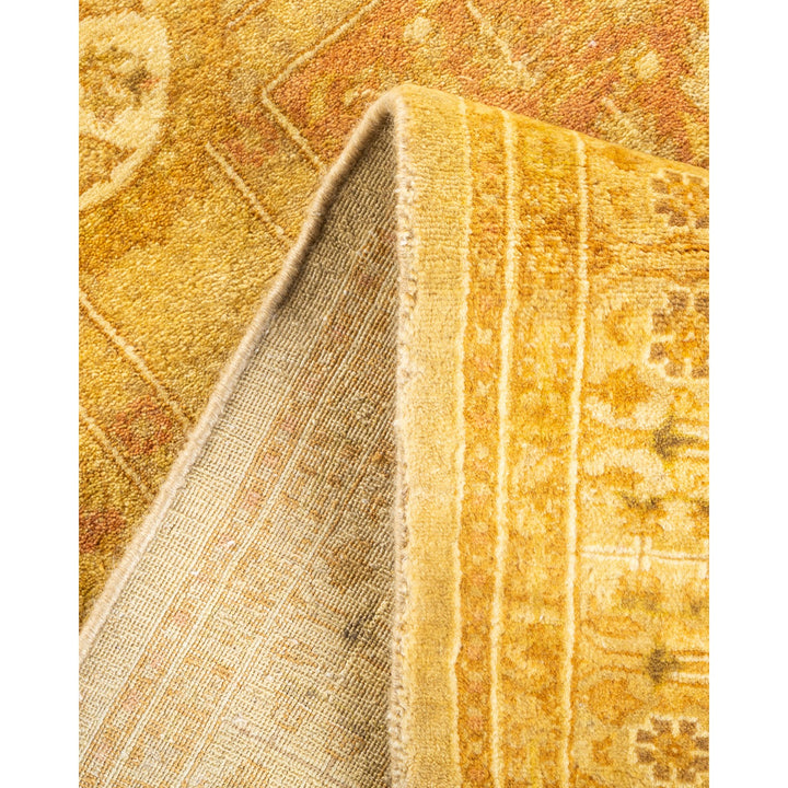 Close-up view of a intricately patterned, warm-toned rug.