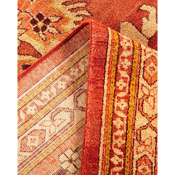 Contrasting fabrics showcase intricate kilim rug and plush floral carpet.