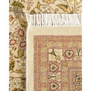 Close-up of two intricately woven rugs showcasing ornate floral and geometric patterns.