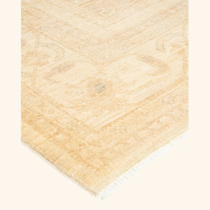 Vintage-inspired patterned rug with subtle faded design on white backdrop.