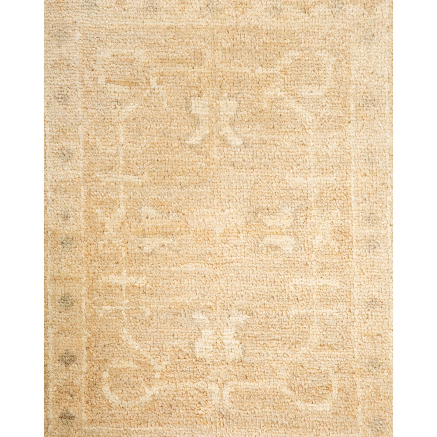 Faded vintage-style rug in neutral beige with subtle floral design