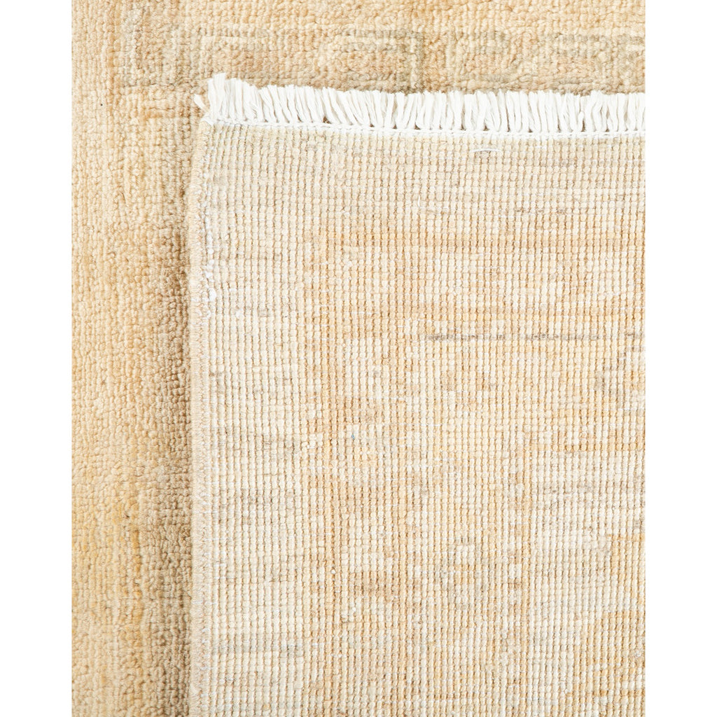 Close-up view of a neutral-toned woven textile with fringe edge.