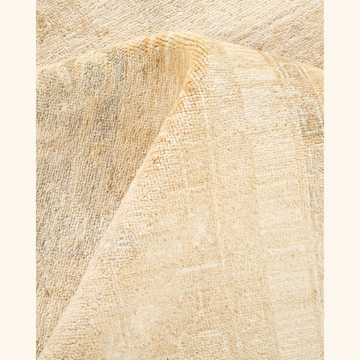 Close-up of fluffy, beige textured fabric with raised surface.