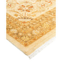 Exquisite hand-woven carpet with intricate Oriental-inspired design and fringe.