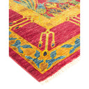 Vibrant, handwoven oriental rug featuring intricate floral and geometric motifs.