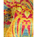 Vibrant, intricate textile with floral and geometric patterns on display.