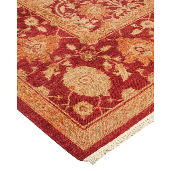 Close-up of an ornate, red and orange rug with intricate patterns.