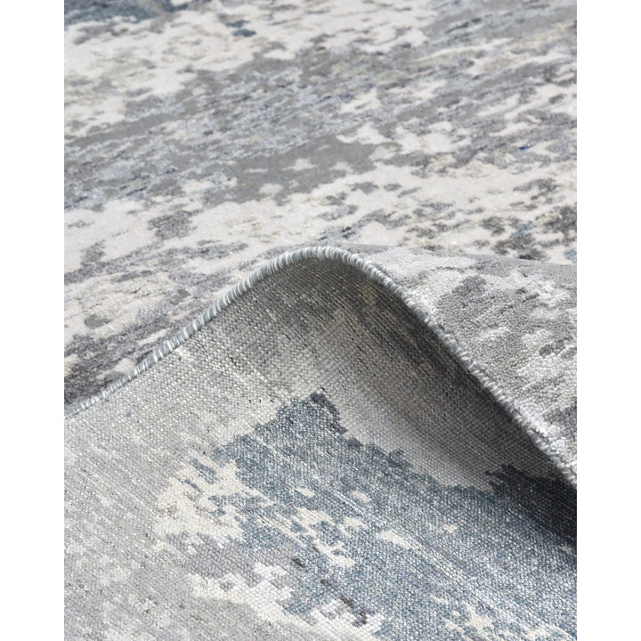 Close-up of a distressed patterned carpet in neutral shades.