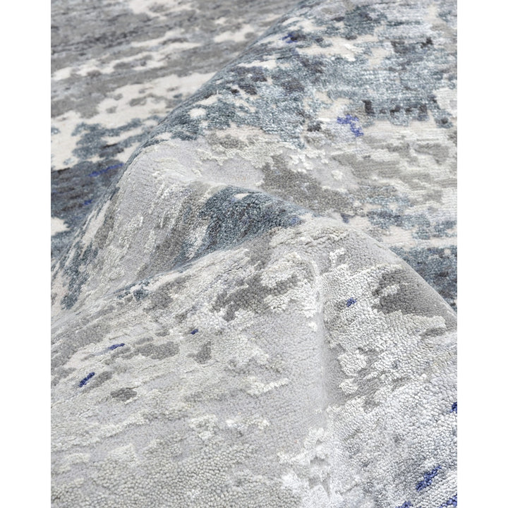 Close-up of a plush, textured rug with abstract gray-blue design.