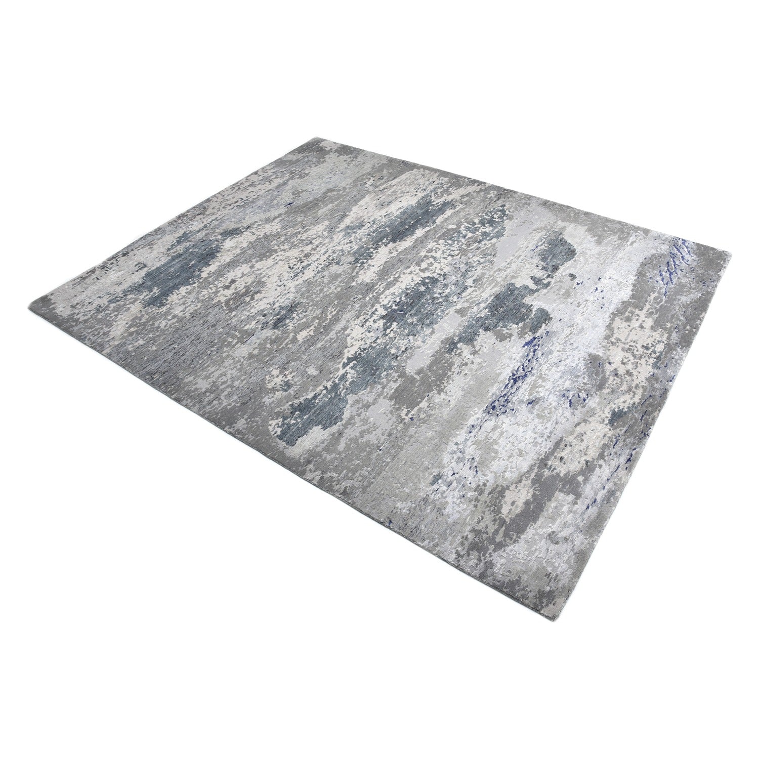 Distressed rectangular rug with muted gray and white pattern design.