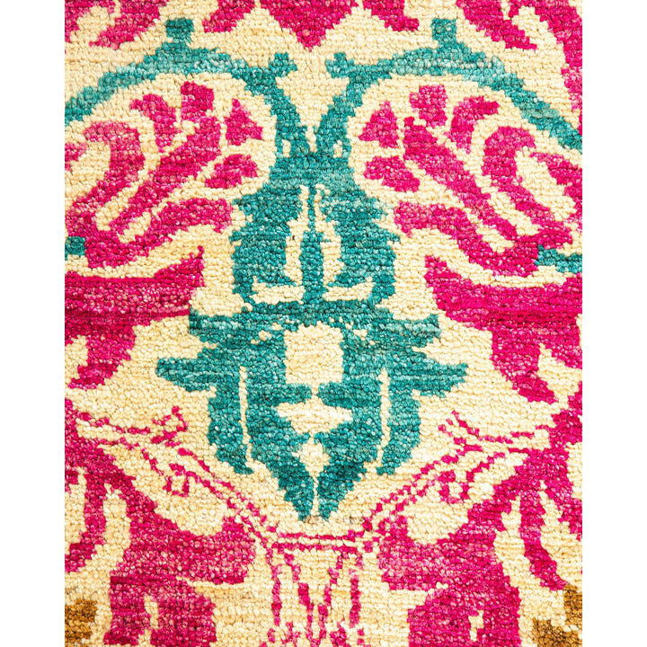Close-up of a colorful, symmetrical rug showcasing intricate floral pattern.