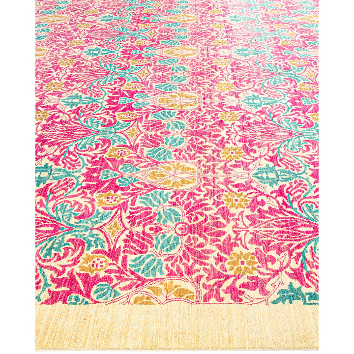Vibrant, ornate floral rug with intricate pink and teal patterns.