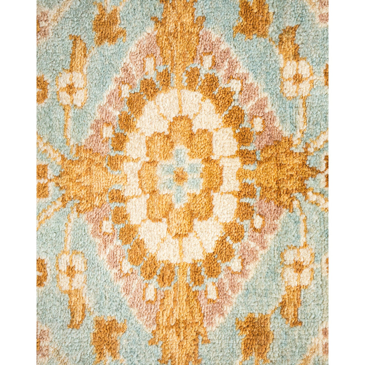 Close-up of an ornate, vintage-inspired carpet with intricate medallion.