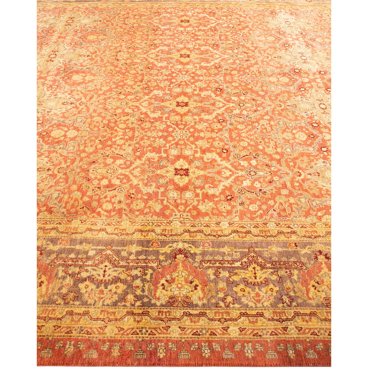 Intricate hand-woven carpet with vibrant orange and red patterns.