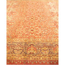Intricate hand-woven carpet with vibrant orange and red patterns.