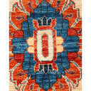 Close-up of a handmade symmetrical carpet with intricate design.