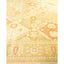 Intricately patterned decorative rug with cream, gold, and orange tones.