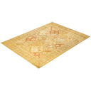 An intricately woven ornate rug with warm colors and symmetrical patterns.