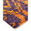Vibrant rug with dynamic pattern showcasing purple and orange hues.