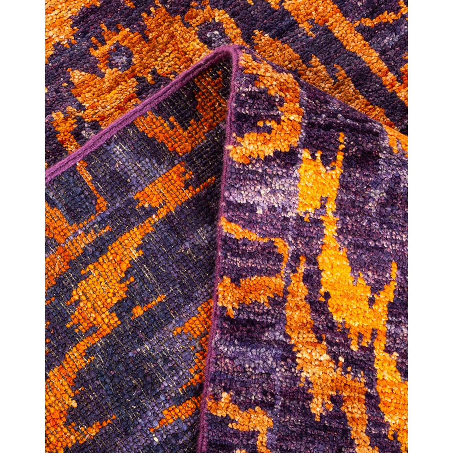 Vibrant purple and orange textured fabric with abstract shapes.