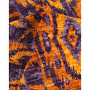 Vibrant purple and orange pattern on tufted, textured fabric.