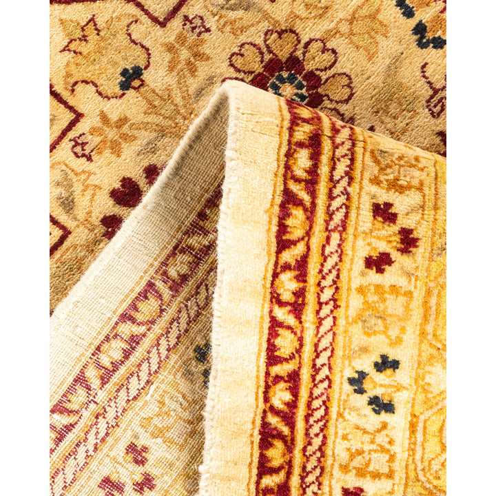 Close-up of folded oriental rug with intricate patterns and colors.