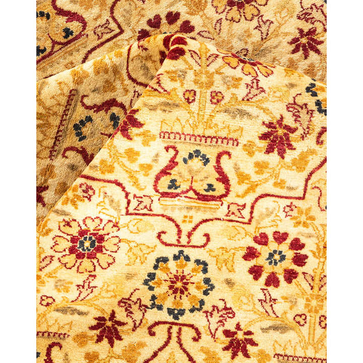 Close-up of an ornate carpet with traditional designs in gold and red.