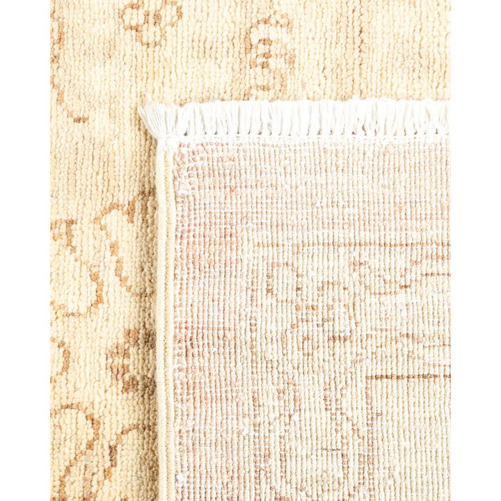 Close-up of a traditional woven carpet with creamy yellow background