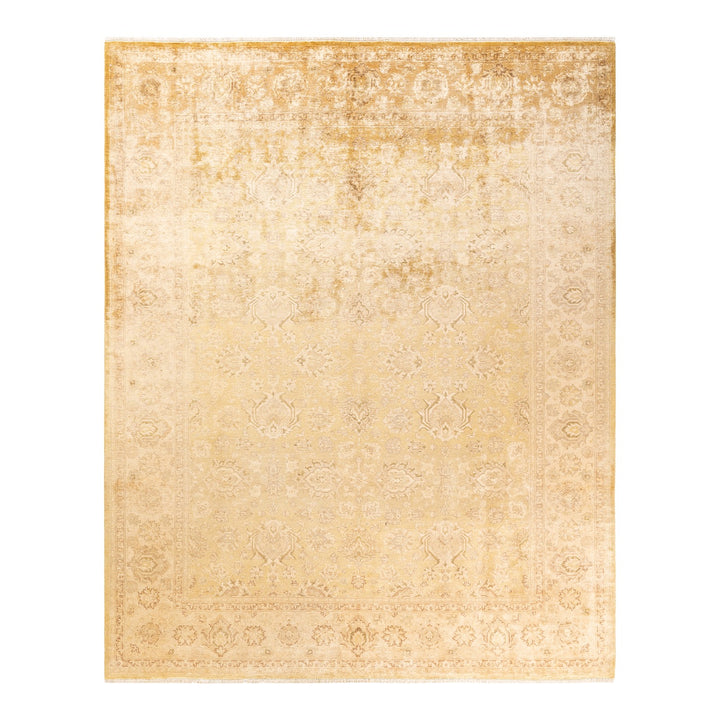 A faded rectangular area rug with an intricate vintage design.