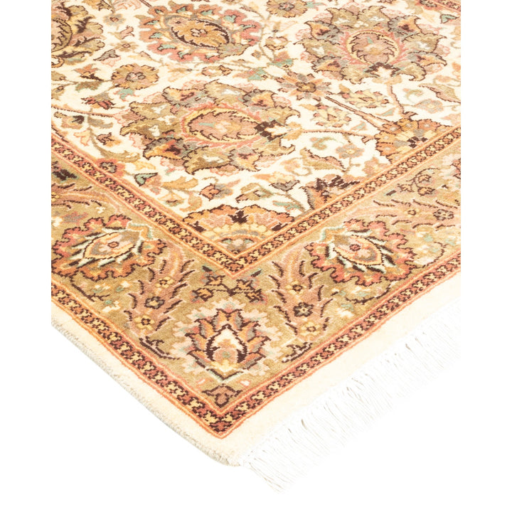 Close-up of an ornate rug with intricate floral pattern.