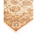 Close-up of an ornate rug with intricate floral pattern.