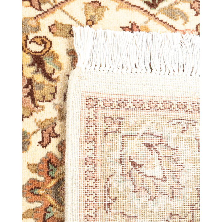 Close-up of a traditional rug with patterned design and fringe.