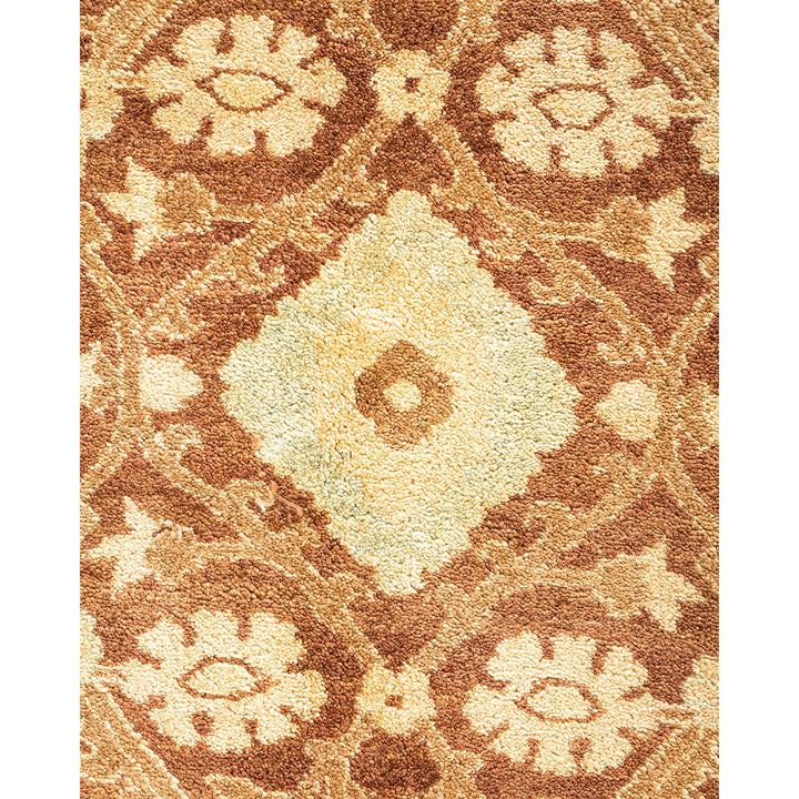Close-up of a plush carpet with intricate diamond and floral motifs.
